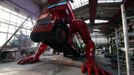 A London bus that has been transformed into a robotic sculpture by Czech artist David Cerny performs press-ups at a factory hall in Prague July 2, 2012. The bus, which Cerny hopes could become an unofficial mascot of the games, does push-ups with the help of an engine powering a pair of robotic arms, and the motion is accompanied by a recording of sounds evoking tough physical effort. It will be parked outside the Czech Olympic headquarters in London for the duration of the Games. Picture taken July 2, 2012. REUTERS/Petr Josek (CZECH REPUBLIC - Tags: SOCIETY SPORT OLYMPICS TRANSPORT) Published: Čec. 22, 2012, 5:59 odp.