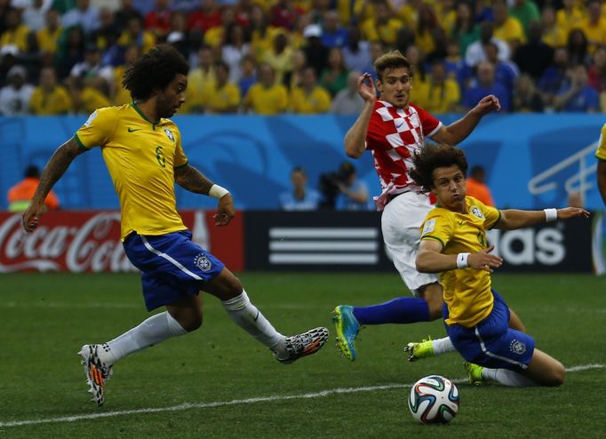 Brazil's Marcelo scores an own goal as Croatia's Nikica Jelavic and Brazil's David Luiz look on during the 2014 World Cup opening match between Brazil and Croatia at the