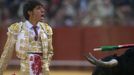 Spanish matador Antonio Nazare reacts in front to a bull during a bullfight in Seville