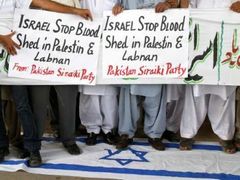 Pákistánští političtí aktivisté stojí na izraelské vlajce během proti-izraelské demonstraci v Multánu.