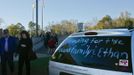 People pass a sign on a vehicle as they leave the funeral for bus driver Charles Albert Poland Jr. at Ozark Civic Center, near Midland City, Alabama, February 3, 2013. Mourners in the small town of Midland City, Alabama, gathered on Sunday to bury a school bus driver slain during the abduction of a child taken captive and held for a sixth day by a gunman in an underground bunker. REUTERS/Phil Sears (UNITED STATES - Tags: CRIME OBITUARY) Published: Úno. 4, 2013, 1:17 dop.