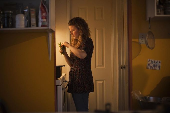 Madison Dewalt, a 'freegan', prepares food that was scavenged by the household in Vancouver, British Columbia April 11, 2012. A 'freegan' is someone who gathers edible food from the garbage bins of grocery stores or food stands that would otherwise have been thrown away. Freegans aim to spend little or no money purchasing food and other goods, not through financial need but to try to address issues of over-consumption and excess. Picture taken April 11, 2012. REUTERS/Ben Nelms (CANADA - Tags: SOCIETY) ATTENTION EDITORS PICTURE 09 OF 21 FOR PACKAGE 'DUMPSTER DIVING FOR FOOD' Published: Kvě. 15, 2012, 11:58 dop.