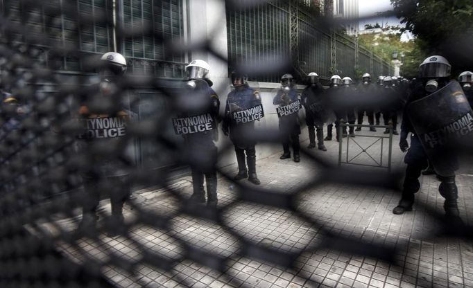 Riot police, seen through a fence surrounding the Greek Parliament, stand in formation during a demonstration against the visit of Germany's Chancellor Angelar Merkel, October 9, 2012. Germany's Angela Merkel arrived in Greece on her first visit since Europe's debt crisis erupted here three years ago, braving protests to deliver a message of support - but no new money - to a nation hammered by recession and fighting to stay in the euro. REUTERS/John Kolesidis (GREECE - Tags: POLITICS BUSINESS) Published: Říj. 9, 2012, 12:32 odp.