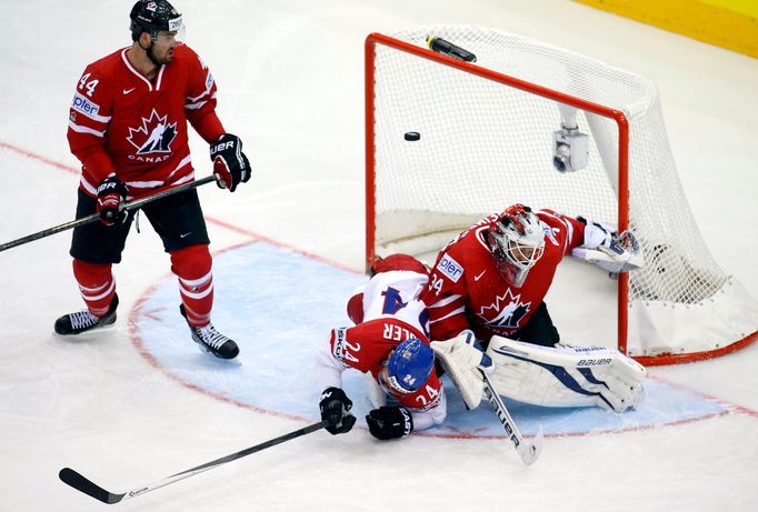 Canada's goaltender James Reimer (R) fails to save a goal of Roman Cervenka (unseen) as team mate Jiri Hudler (C) of the Czech Republic falls during the first period of t