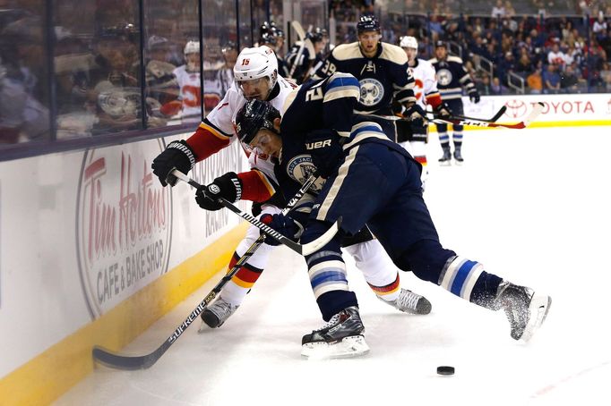 Oct 17, 2014; Columbus, OH, USA; Columbus Blue Jackets right wing Corey Tropp (26) battles for the puck against Calgary Flames defenseman Ladislav Smid (15) during the se