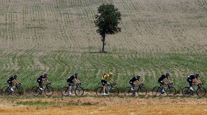 The pack of riders including Race leader yellow jersey holder Team Sky rider Christopher Froome (C) of Britain cycles during the 242.5 km fifteenth stage of the centenary