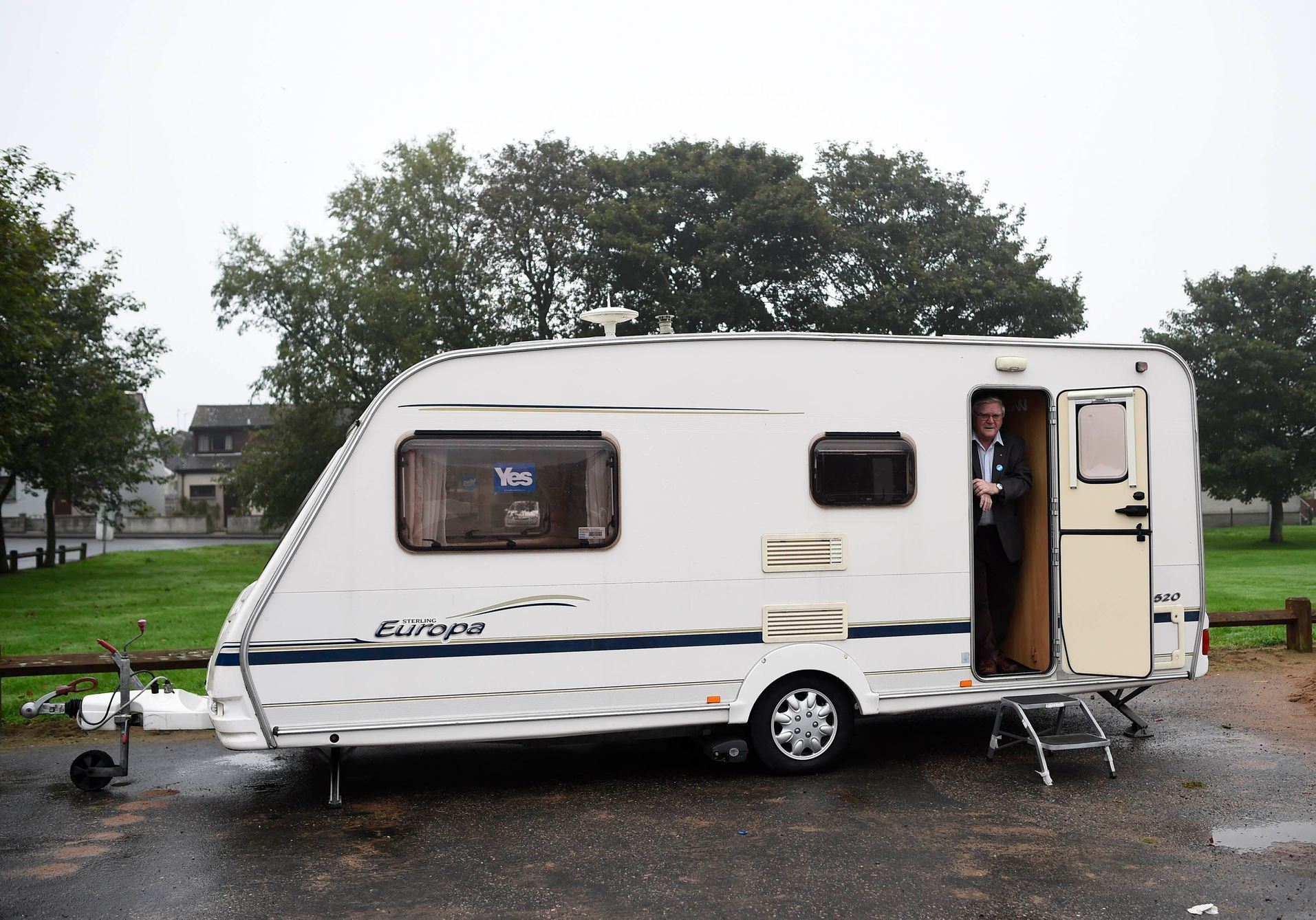 A man stands in a caravan parked outside a polling station during the referendum on Scottish independence in Strichen