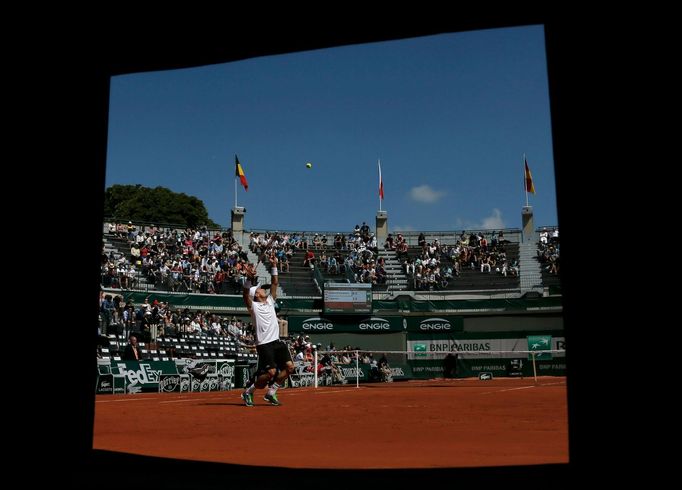 Roberto Bautista Agut of Spain serves during the men's singles match against Florian Mayer of Germany at the French Open tennis tournament at the Roland Garros stadium in