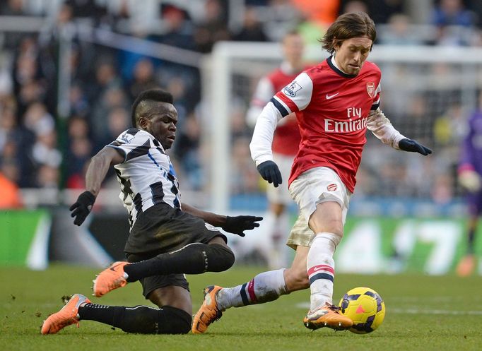 Newcastle United's Tiote challenges Arsenal's Rosicky during their English Premier League soccer match in Newcastle