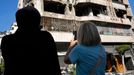 Lebanese women stand in front an apartment in a multistory building hit by Israeli airstrike, in central Beirut, Lebanon, Thursday, Oct. 3, 2024. (AP Photo/Hussein Malla)