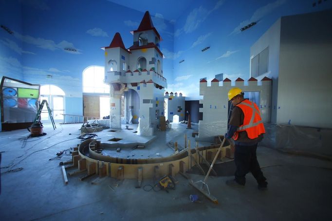 A worker sweeps the lobby entrance as construction continues in North America's first ever Lego Hotel being built at Legoland in Carlsbad, California January 17, 2013. The three-story, 250-room hotel will open on April 5. REUTERS/Mike Blake (UNITED STATES - Tags: SOCIETY TRAVEL) Published: Led. 17, 2013, 10:22 odp.