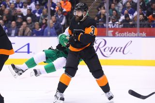 Mar 15, 2019; Toronto, Ontario, CAN; Philadelphia Flyers defenseman Radko Gudas (3) knocks down Toronto Maple Leafs left wing Zach Hyman (11) in the second period at Scot
