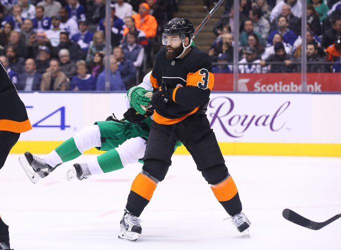 Mar 15, 2019; Toronto, Ontario, CAN; Philadelphia Flyers defenseman Radko Gudas (3) knocks down Toronto Maple Leafs left wing Zach Hyman (11) in the second period at Scot