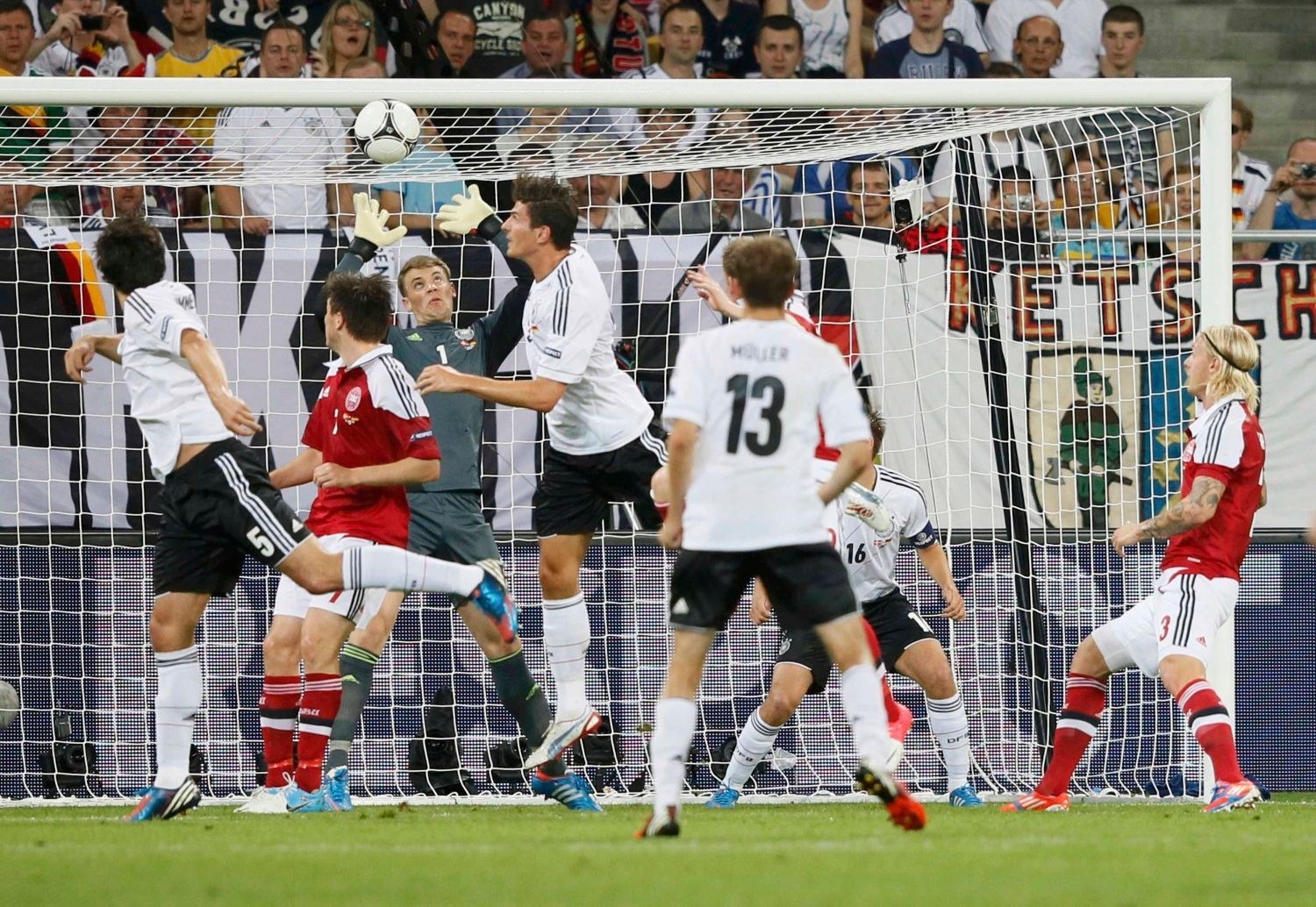 Německý brankář Manuel Neuer marně sahá po hlavičce Dána Michaela Krohn-Dehliho v utkání skupiny B na Euru 2012