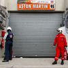 A race steward stands in front of the pit lane of Aston Mart