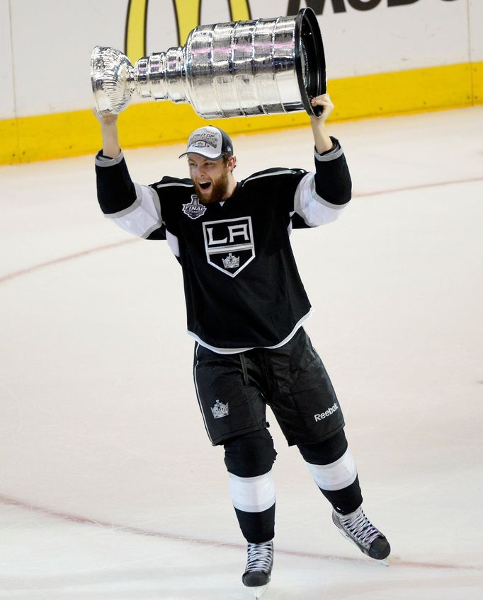 Jun 13, 2014; Los Angeles, CA, USA; Los Angeles Kings defenseman Jake Muzzin (6)hoists the Stanley Cup after defeating the New York Rangers in the second overtime period