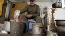 Villager Shamianok prepares food for his cattle in his house at abandoned village of Tulgovichi