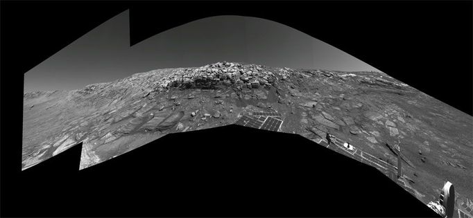 No Shortcut for Opportunity (Right Eye) As NASA's Mars Exploration Rover Opportunity was making its way back toward its original entry path into "Endurance Crater," scientists and engineers spotted what they hoped might be a shortcut for climbing out of the crater. The possible exit path, pictured on the far right of this image where the outcrop is punctuated, was eventually deemed too hazardous for the rover to attempt. Opportunity would have had to cross terrain with a slope of 28 degrees and face a tall rock outcropping very close to the exit chute opening which, itself, is too narrow for the rover to pass. This view combines several frames taken by the rover's navigation camera during Opportunity's 297th sol on Mars (Nov. 24, 2004). It is the right-eye member of a stereo pair presented in a cylindrical-perspective projection with geometric seam correction. The location from which the image was taken has been designated as Opportunity's Site 38, Position 97. Image credit: NASA/JPL