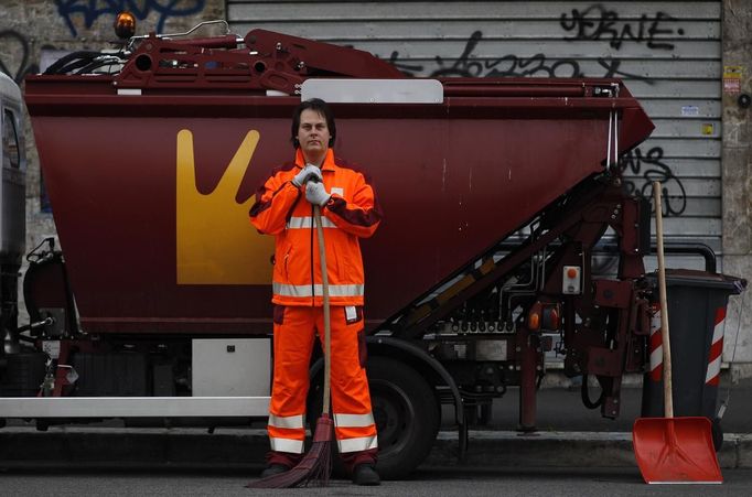 Francesco Foglia, 37, poses for a picture as he works as a street sweeper in downtown Rome April 29, 2012. Foggia studied for six years at university in Rome where he received a degree and a doctorate in industrial chemistry. He hoped to find a job as a researcher but has been working as a street sweeper for Rome's municipality for two years.