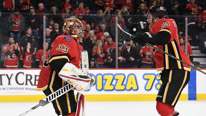 Mar 10, 2019; Calgary, Alberta, CAN; Calgary Flames goalie David Rittich (33) and left wing Matthew Tkachuk (19) celebrate the win over the Las Vegas Golden Knights at Sc