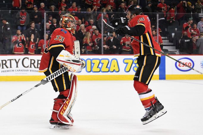 Mar 10, 2019; Calgary, Alberta, CAN; Calgary Flames goalie David Rittich (33) and left wing Matthew Tkachuk (19) celebrate the win over the Las Vegas Golden Knights at Sc