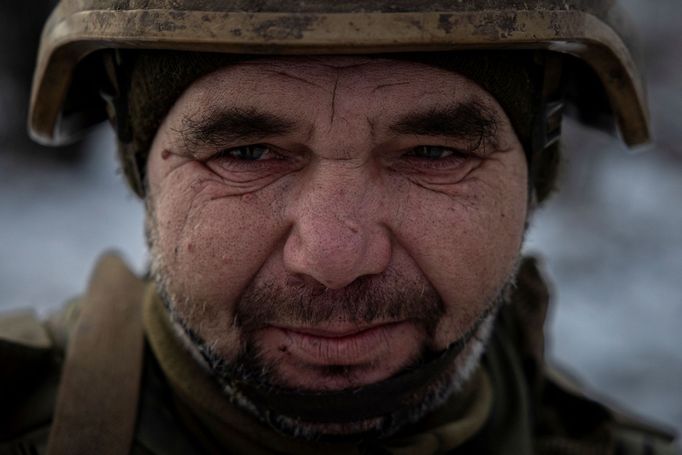 A Ukrainian serviceman of the 93rd separate mechanized brigade attends a Christmas Day service near the front line in the Donetsk region as Ukrainians celebrate their fir