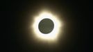 The moon passes in front of the sun during a full solar eclipse at Palm Grove near the northern Australian city of Cairns November 14, 2012. A rare full solar eclipse plunged north Queensland into darkness for two minutes early on Wednesday, delighting the thousands of people who had gathered on the Australian state's beaches. In Cairns, the main city in north Queensland and a gateway to the Great Barrier Reef, cloudy skies and occasional rain partly obscured the view, but elsewhere viewing conditions were more favourable. REUTERS/Tourism Queensland/Handout (AUSTRALIA - Tags: SOCIETY ENVIRONMENT) FOR EDITORIAL USE ONLY. NOT FOR SALE FOR MARKETING OR ADVERTISING CAMPAIGNS Published: Lis. 14, 2012, 1:54 dop.