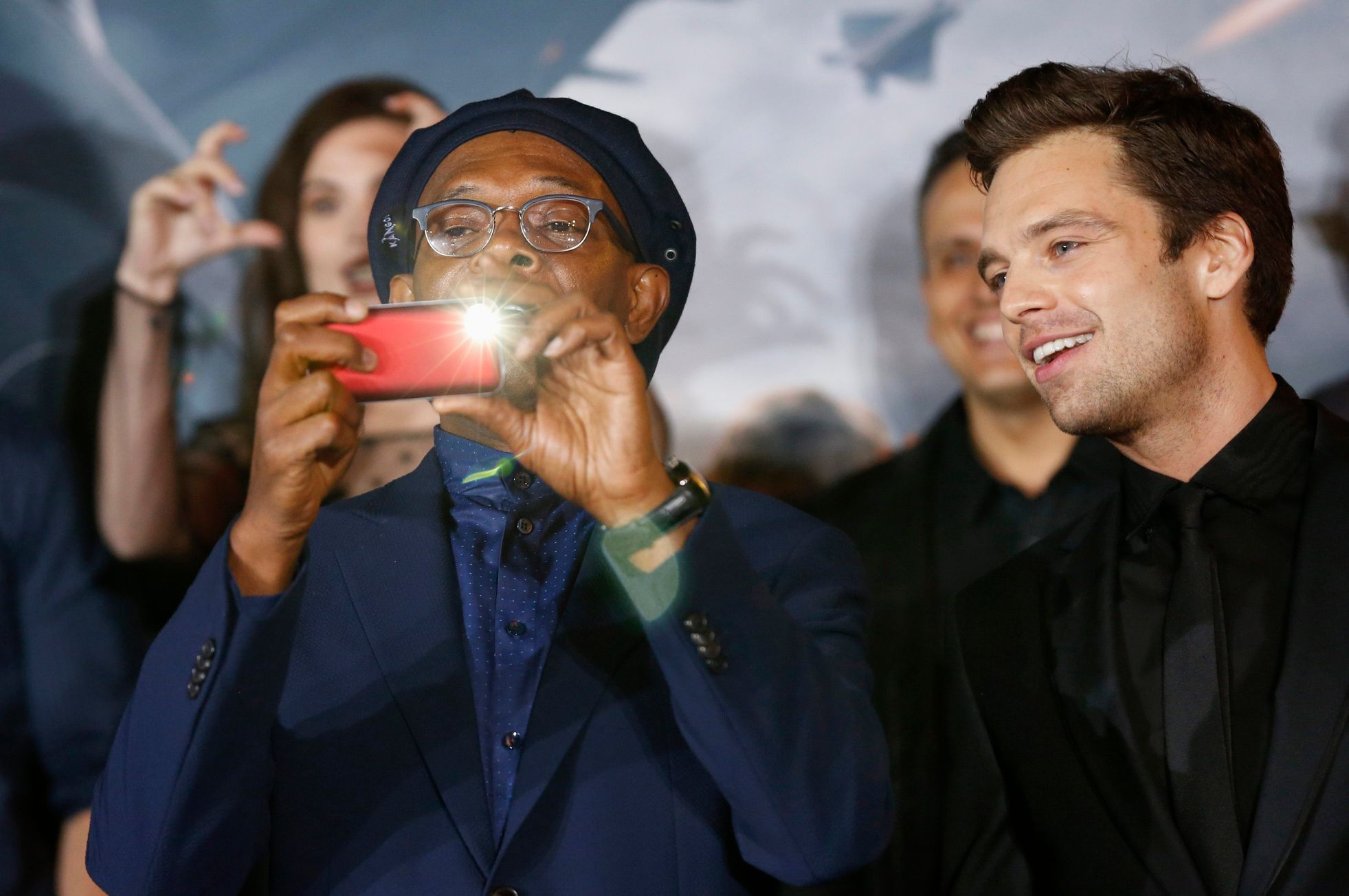 Cast member Jackson takes a photo with his mobile device next to co-star Stan at the premiere of &quot;Captain America: The Winter Soldier&quot; in Hollywood