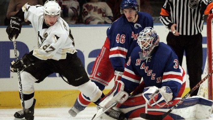 Sidney Crosby z Pittsburghu (vlevo) se připravuje ke střele před gólmanem New Yorku Rangers Henrikem Lundqvistem (vpravo), vzadu newyorský Ryan Hollweg.