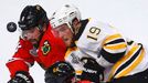 Boston Bruins' Tyler Seguin (19) battles for the puck with Chicago Blackhawks' Nick Leddy (8) and Michal Rozsival (32) during the first period in Game 1 of their NHL Stan