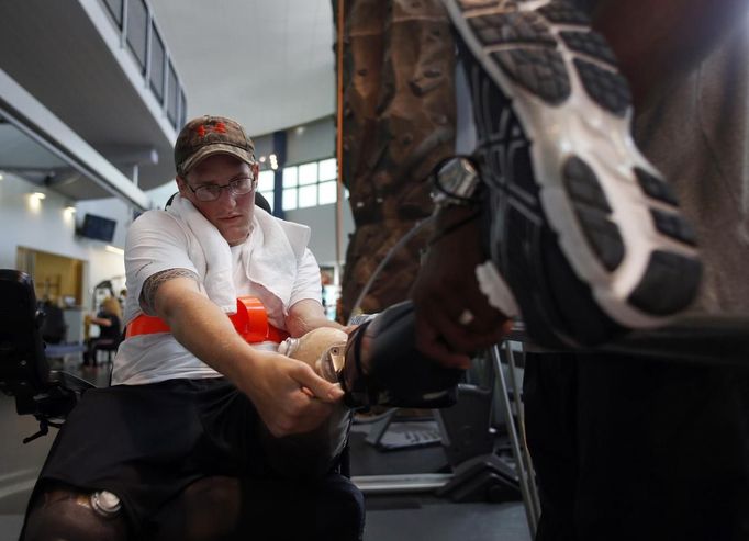 Sgt. Matt Krumwiede of the U.S. Army attaches his prosthetic leg before practicing walking with physical therapist Troy Hopkins at the Center for the Intrepid at Brooke Army Medical Center in San Antonio, Texas August 1, 2013. On June 12, 2012, Krumwiede was on patrol in Afghanistan when he stepped on an IED, which tore away both his legs, damaged his left arm, and ripped open his abdominal cavity. The 22-year-old has since undergone around 40 surgeries and is learning to walk with prosthetic legs. He is keen to re-join the infantry as soon as his injuries allow. U.S. troops have been in Afghanistan since 2001. Thousands of Afghan elders gathered in Kabul on November 21, 2013 at a Loya Jirga, or grand council, to debate a crucial security pact with the United States, a day after Kabul and Washington reached a draft agreement laying out the terms under which U.S. troops may stay beyond 2014. Picture taken August 1, 2013.