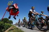 Skupinka cyklistů projíždí kolem cyklistického nadšence Didiho Senfta, známého také jako "El Diablo" (Čert), během 190,5 km dlouhé 7. etapy 102. Tour de France z Livarot do Fougeres, Francie, 10. června 2015.