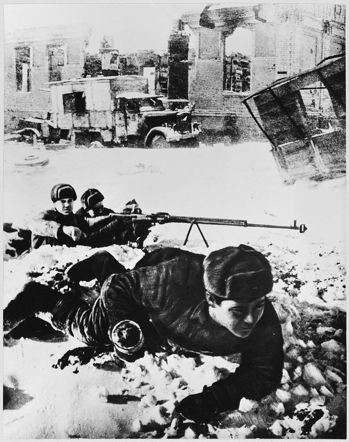 SOLDIERS AMONGST RUINS Red Army soldies lie in wait amongst the ruins Date: 1942 - 1943 Source: Unattributed photograph from the Alexander meledin Collection