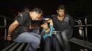 Suspected members of the Mara 18 street gang sit on a pick-up truck after their arrest after a shoot-out with police and military during an anti-drug operation in San Pedro Sula March 27, 2013. San Pedro Sula, the country's second largest city after Tegucigalpa, has a homicide rate of 169 per 100,000 people and was named the world's most violent city for a second year in a row. Lax laws allow civilians to own up to five personal guns, and arms trafficking has flooded the country with nearly 70% illegal firearms. 83.4% of homicides are by firearm compared to 60% in the United States. Picture taken March 27, 2013. REUTERS/Jorge Cabrera (HONDURAS - Tags: CRIME LAW CIVIL UNREST HEALTH) ATTENTION EDITORS: PICTURE 9 OF 39 FOR PACKAGE 'GUN CULTURE - HONDURAS' SEARCH 'HONDURAS GUN' FOR ALL IMAGES Published: Dub. 5, 2013, 11:14 dop.