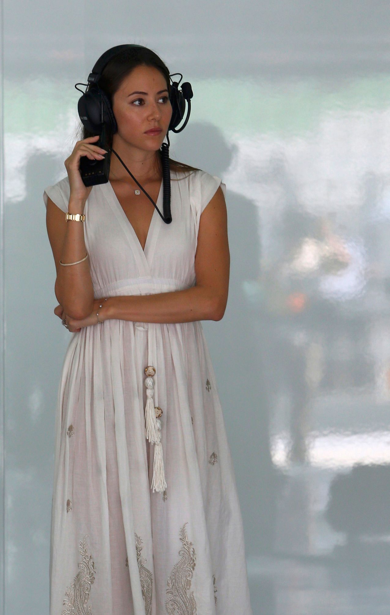 Jessica Michibata listens to the radio during the first practice session of the Malaysian F1 Grand Prix at Sepang International Circuit outside Kuala Lumpur