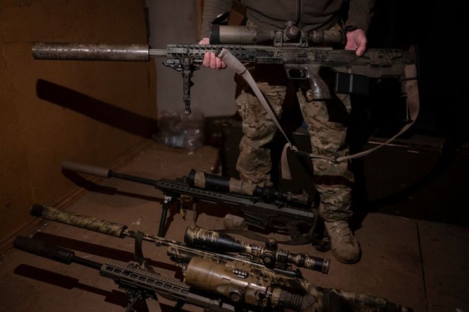 A Ukrainian Army sniper shows his rifle at a temporary base near a front line, amid Russia's attack on Ukraine, in Donetsk region, Ukraine December 23, 2023. REUTERS/Viac