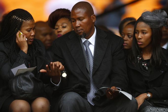 Mandla Mandela (C), eldest grandson of former South African President Nelson Mandela, attends the official memorial service for Nelson Mandela at the First National Bank stadium, also known as Soccer City, in Johannesburg December 10, 2013.