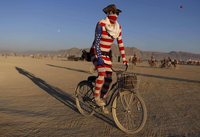 Nick", his playa name, rides across the desert during the Burning Man 2012 "Fertility 2.0" arts and music festival in the Black Rock Desert of Nevada August 29, 2012. More than 60,000 people from all over the world have gathered at the sold out festival, which is celebrating its 26th year, to spend a week in the remote desert cut off from much of the outside world to experience art, music and the unique community that develops.