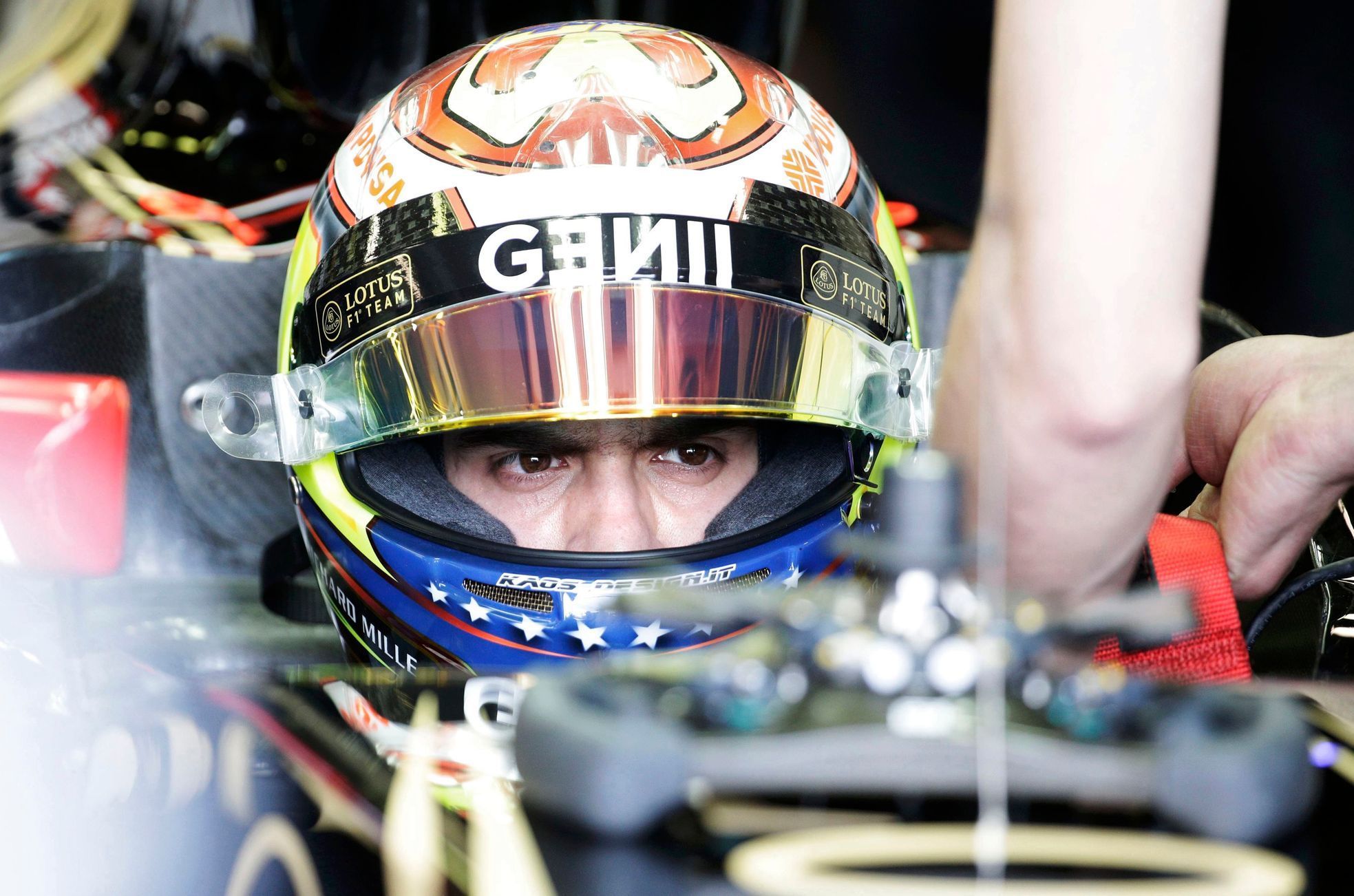 Lotus Formula One driver Pastor Maldonado of Venezuela sit in his car in the team garage during the third practice session of the Australian F1 Grand Prix at the Albert Park circuit in Melbourne