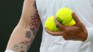 Bethanie Mattek-Sands of the U.S. holds tennis balls during her women's singles tennis match against Angelique Kerber of Germany at the Wimbledon Tennis Championships, in