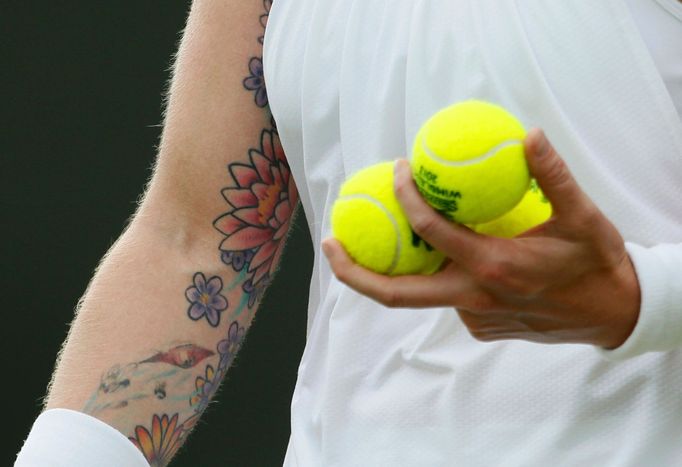 Bethanie Mattek-Sands of the U.S. holds tennis balls during her women's singles tennis match against Angelique Kerber of Germany at the Wimbledon Tennis Championships, in