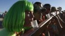 A woman of the playa name "Indigo" participates in a drinking game during the Burning Man 2012 "Fertility 2.0" arts and music festival in the Black Rock Desert of Nevada August 29, 2012. More than 60,000 people from all over the world have gathered at the sold out festival, which is celebrating its 26th year, to spend a week in the remote desert cut off from much of the outside world to experience art, music and the unique community that develops.