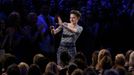 Actress Shailene Woodley celebrates with the crowd as she wins the award for Best Female Performance at the 2015 MTV Movie Awards in Los Angeles