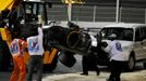 The car of Sauber Formula One driver Esteban Gutierrez of Mexico is removed from the track during the Bahrain F1 Grand Prix at the Bahrain International Circuit (BIC) in