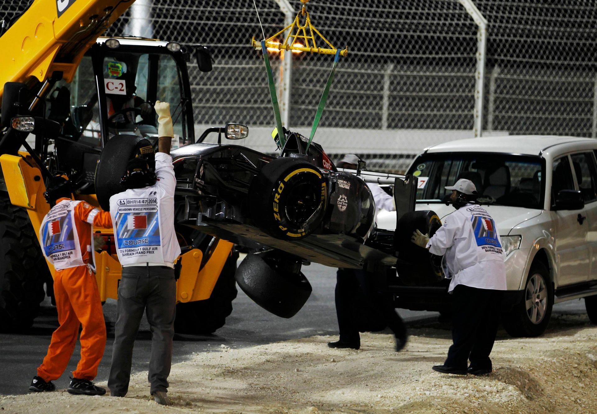 The car of Sauber Formula One driver Esteban Gutierrez of Mexico is removed from the track during the Bahrain F1 Grand Prix at the Bahrain International Circuit (BIC) in Sakhir