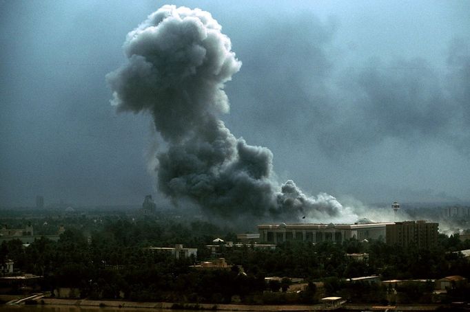 Iraq Through the Fall Smoke rises above one of Saddam Hussein's Presidential Palaces in Baghdad March 21, 2003, after air strikes during the U.S.-led coalition invasion of Iraq.