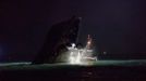 Rescuers approach a partially-submerged boat after two vessels collided in Hong Kong October 1, 2012. A major rescue is underway in the waters near Yung Shue Wan on Hong Kong's Lamma island following a collision involving two vessels in the evening, government radio reported on Monday. Police say there were about 100 people onboard both vessels, with many of them in the water. The government says 101 people have been rescued so far with at least 25 hospitalised. REUTERS/Tyrone Siu (CHINA - Tags: DISASTER TRANSPORT) Published: Říj. 1, 2012, 6:18 odp.