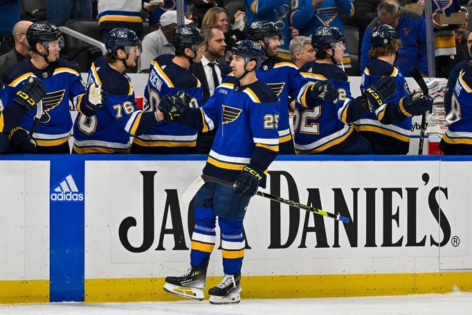 Apr 10, 2024; St. Louis, Missouri, USA;  St. Louis Blues center Jordan Kyrou (25) is congratulated by teammates after scoring against the Chicago Blackhawks during the fi