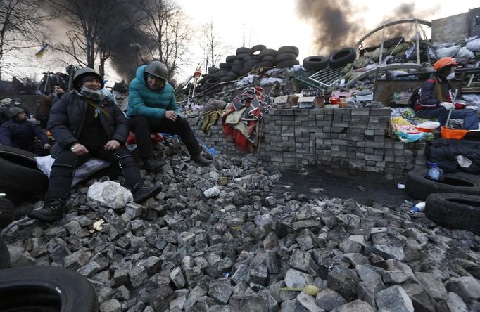 Anti-government protesters rest at a barricade in Kiev February 21, 2014.