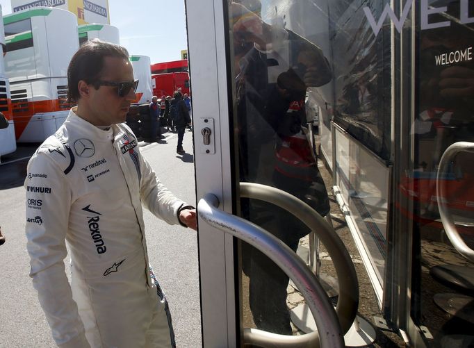 .Williams F1 driver Felipe Massa opens a door in the paddock.